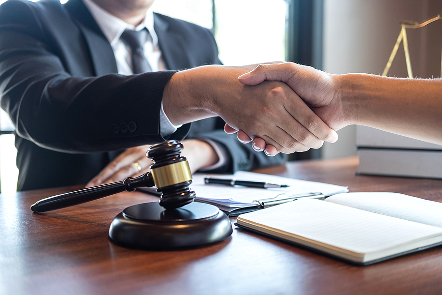 Handshake after good deal negotiation cooperation, Professional male lawyer or counselor and client meeting, working with legal case document contract in office, law and justice, attorney, lawsuit.