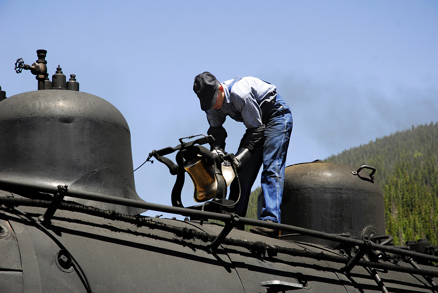 railroad worker inspecting train engine